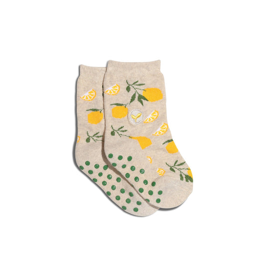 Beige socks with lemon and polka dot pattern on a white background
