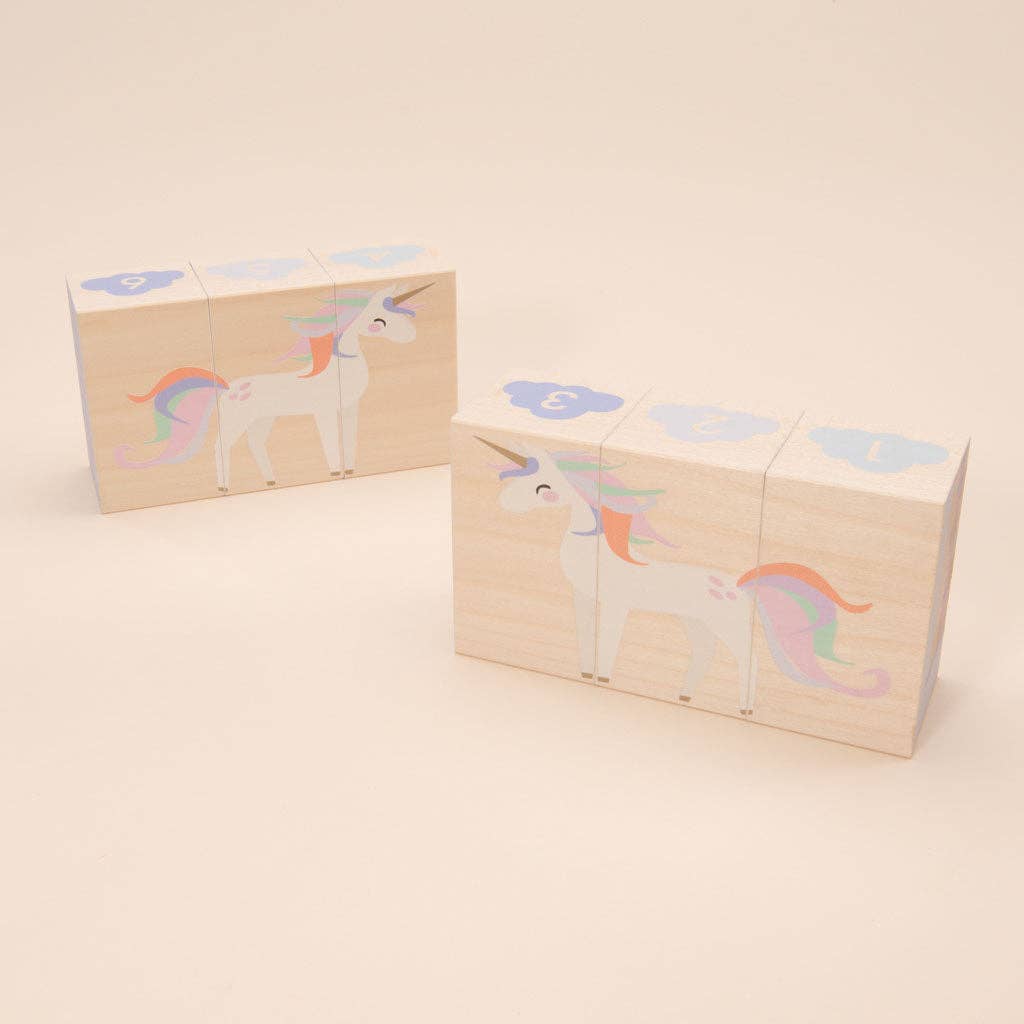 Set of wooden blocks with unicorn designs on a beige background