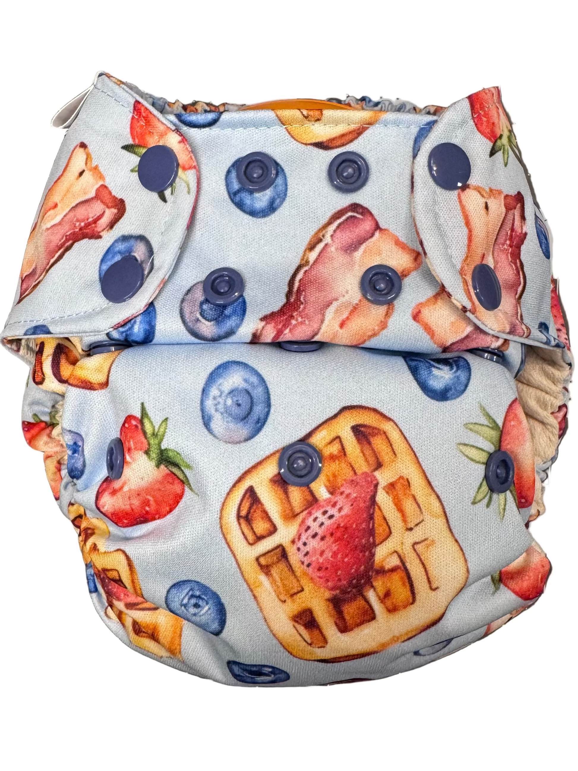 Patterned diaper with waffles, strawberries, and blueberries on a white background