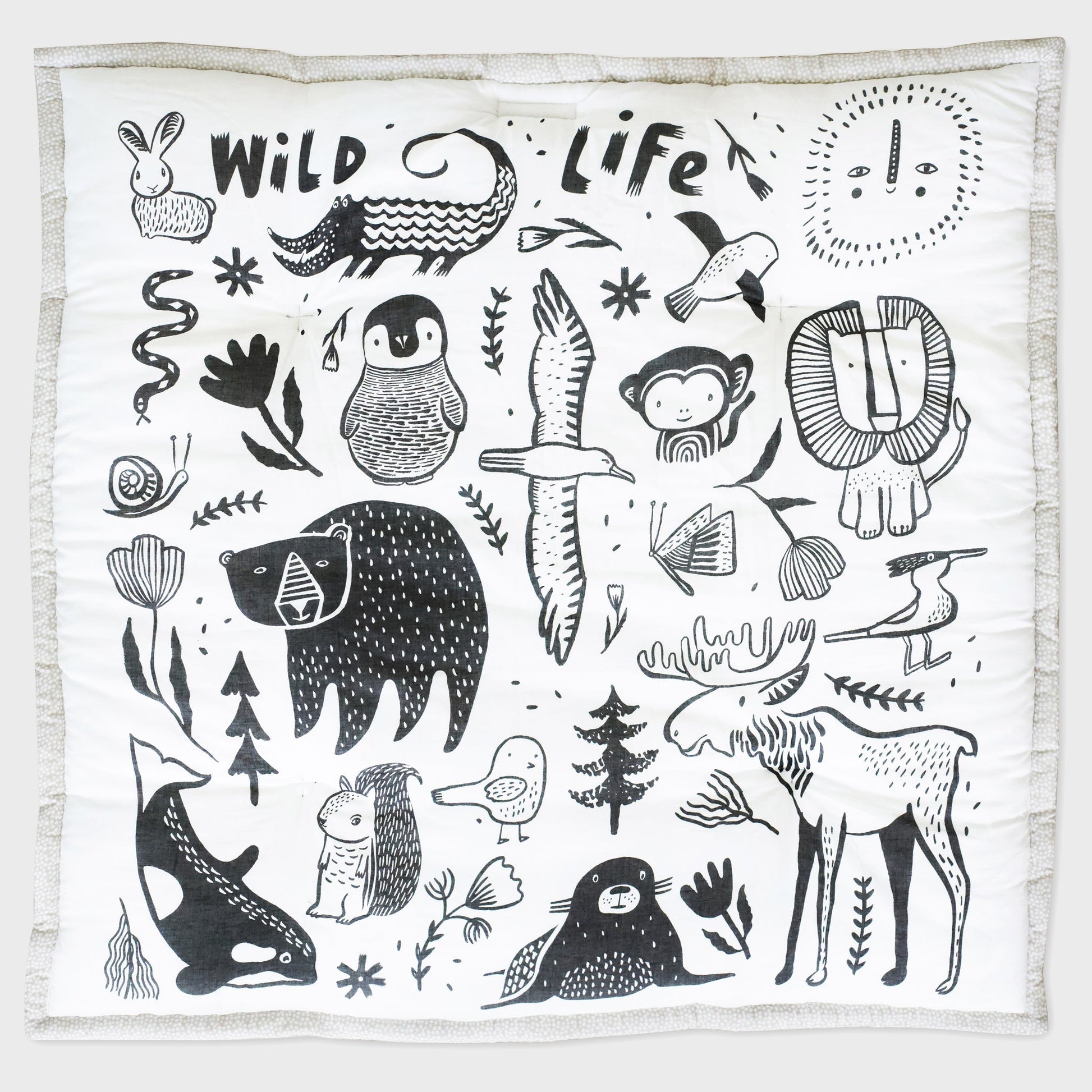 White blanket with black animal illustrations and 'Wild Life' text