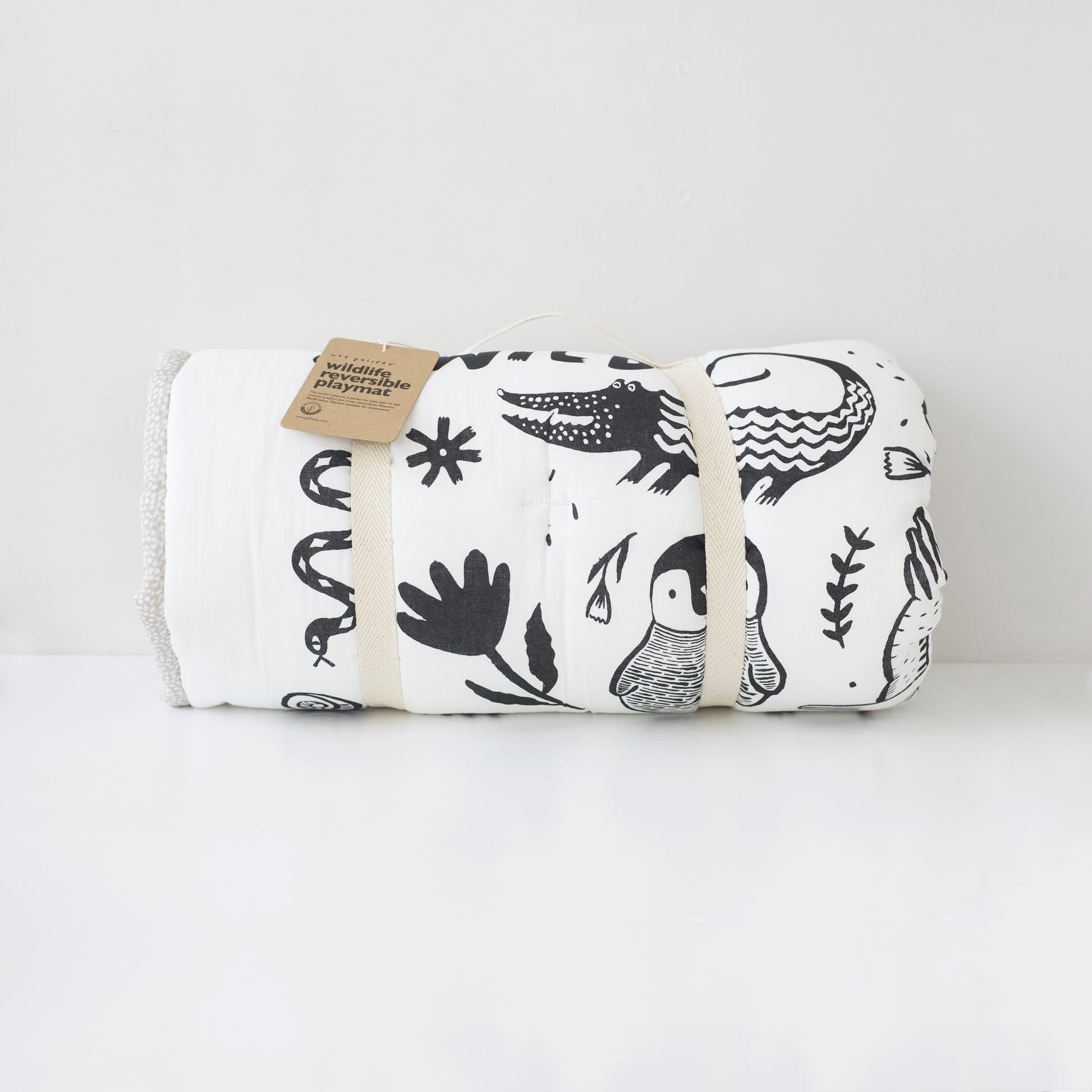 Folded blanket with black patterns on a white background