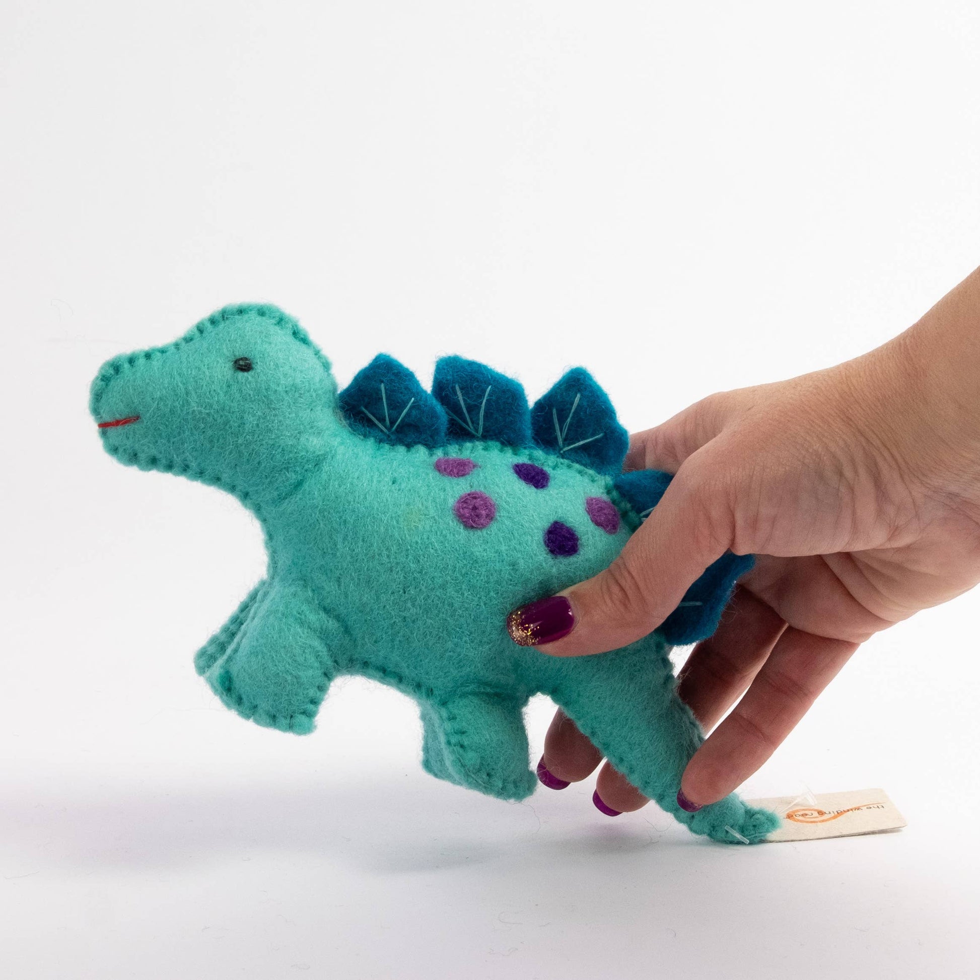 hand holding felt blue baby dinosaur