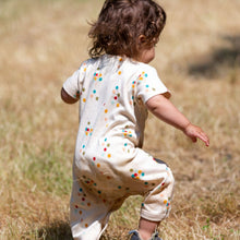 Load image into Gallery viewer, Baby running in a grass field wearing Rainbow Balloons Organic Summer Romper
