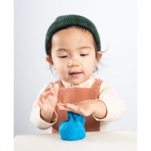 kid playing with blue eco play dough