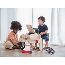 Load image into Gallery viewer, Kids playing with the Motor Mechanic by Plan Toys

