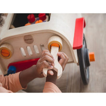 Load image into Gallery viewer, child playing with the Motor Mechanic by Plan Toys
