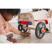 Load image into Gallery viewer, kid playing with the Motor Mechanic by Plan Toys
