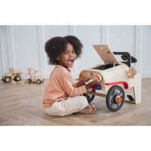 Load image into Gallery viewer, Kid playing with the Motor Mechanic by Plan Toys
