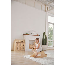 Load image into Gallery viewer, Child riding the PlanToys Palomino Modern Rustic in a play room
