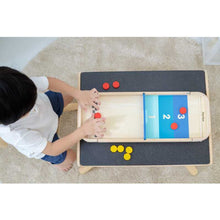 Load image into Gallery viewer, Child playing Shuffleboard-Game by Plan Toys
