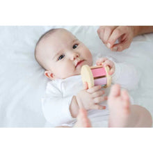 Load image into Gallery viewer, Baby laying on a bed holding pastel roller with sound
