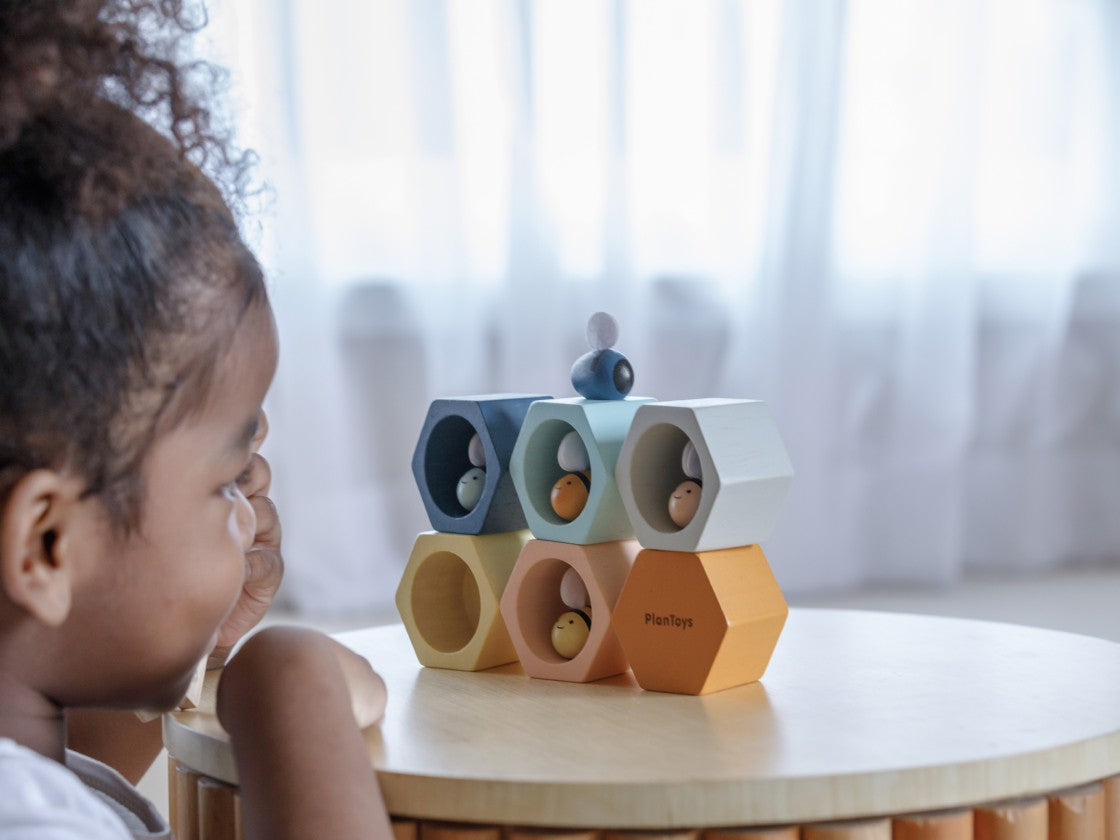 child playing with Beehive- in Orchard by plan toys