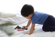 Load image into Gallery viewer, child crawling on a bed playing with small wooden sea creatures figures
