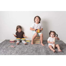 Load image into Gallery viewer, Children sitting on a grey rug playing with musical instruments by PlanToys
