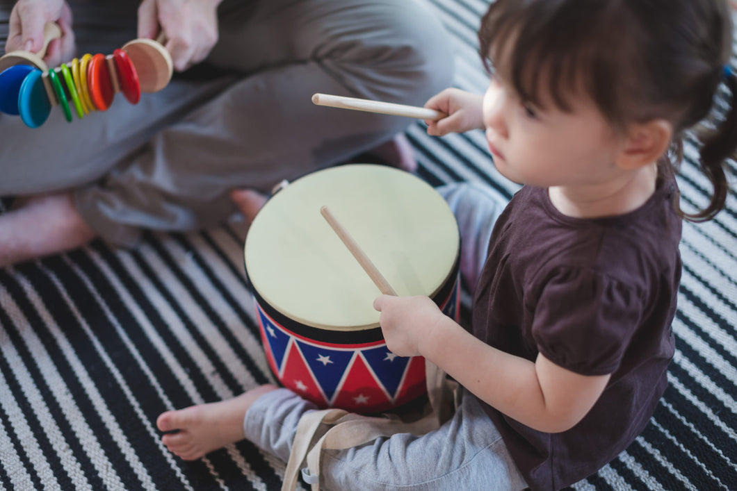 Child Playing with Plan toys Big Drum