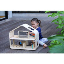 Load image into Gallery viewer, Child Playing with a Contemporary Dollhouse by Plan Toys

