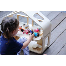 Load image into Gallery viewer, child playing with a Contemporary Dollhouse by Plan Toys
