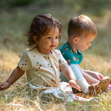 Load image into Gallery viewer, Two babies sitting in a grass field wearing Rainbow Balloons Organic Summer Romper
