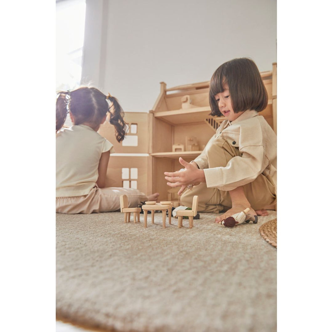 Child playing with PlanToys Victorian Furniture and Doll House
