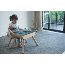Load image into Gallery viewer, child sitting at the kids black Table &amp; Chair Set By Plan Toys
