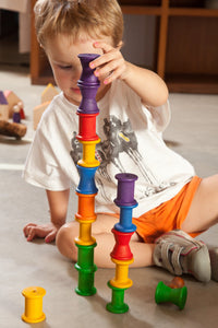 Child stacking rainbow spools
