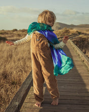 Load image into Gallery viewer, ocean silk cape on a child on a board walk in overalls
