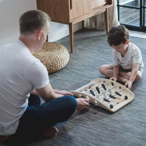 Child and adult playing with DIY wooden Pin Ball Game by Plan Toys