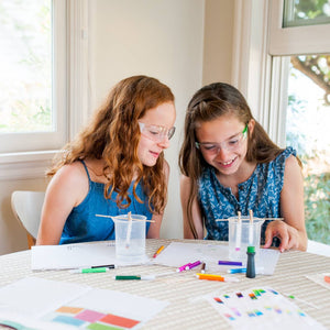 Children playing with the Paper Chromatography: The Art & Science of Color kit