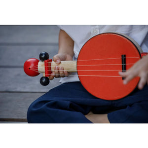 Child Playing a Banjo by Plan Toys