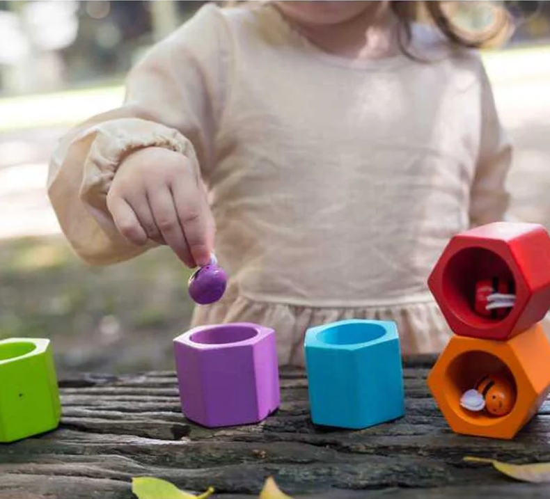 child playing with a bee hive 