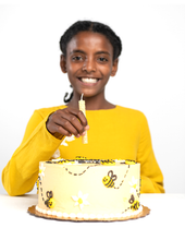 Load image into Gallery viewer, Kid holding a beeswax candle over a cake
