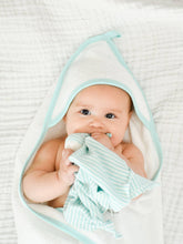 Load image into Gallery viewer, Baby laying on a white blanket wrapped in aOrganic Aqua Deluxe Hooded Towel
