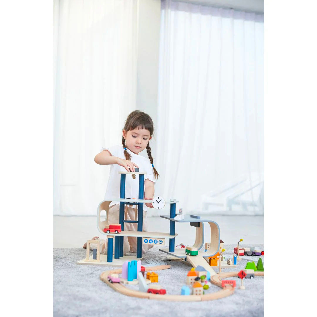 Child playing with plan toys central station