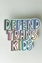 Load image into Gallery viewer, A holographic sticker with the words &quot;Defend Trans Kids&quot;
