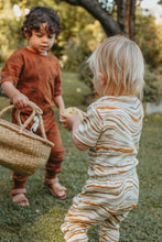 Load image into Gallery viewer, Children playing outside one child wearing Ziwi baby wave onesie and pants onesie or bodysuit
