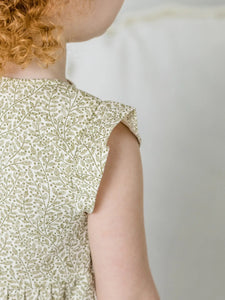 detail of child wearing Tilly Tiered Dress in Fern + Ivory