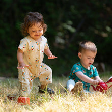 Load image into Gallery viewer, Two babies playing with a tea set in a grass field, one wearing Rainbow Balloons Organic Summer Romper
