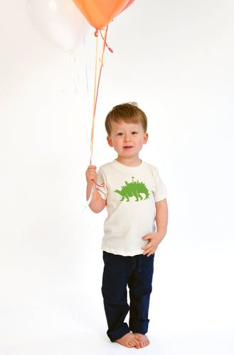 Child holding balloons wearing seattlesaurus organic kids tee