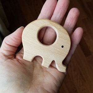 Elephant wooden teether in hand