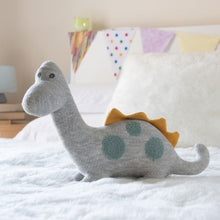 Load image into Gallery viewer, Large Grey Diplodocus Plush Toy on a Bed
