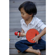 Load image into Gallery viewer, Child  sitting Playing a Banjo by Plan Toys
