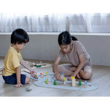 Load image into Gallery viewer, Kids playing with the plan toys rubber railroad set
