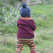 Load image into Gallery viewer, child walking outside wearing a hat, sweater, and rainbow striped joggers

