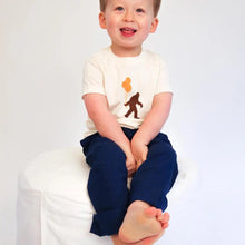 Load image into Gallery viewer, child sitting down wearing organic Sasquatch &amp; balloons tee
