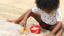 Load image into Gallery viewer, child on the beach playing with sand play set
