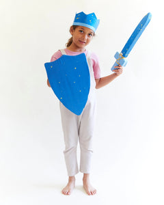 child wearing starry night crown, shield, and sword