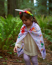 Load image into Gallery viewer, Child wearing a playsilk cape and a unicorn silk headband in the woods
