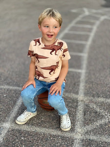 Child wearing Juno short sleeve dinosaur tee by The Striped Cat