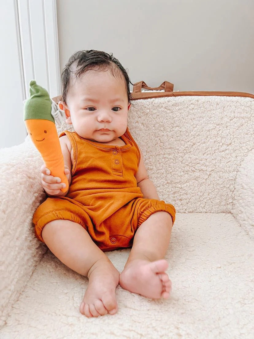 Baby with organic plush carrot teether by Under The Nile