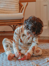 Load image into Gallery viewer, chid playing on the floor wearing a matching long autumn leaf set by ZiwiBaby

